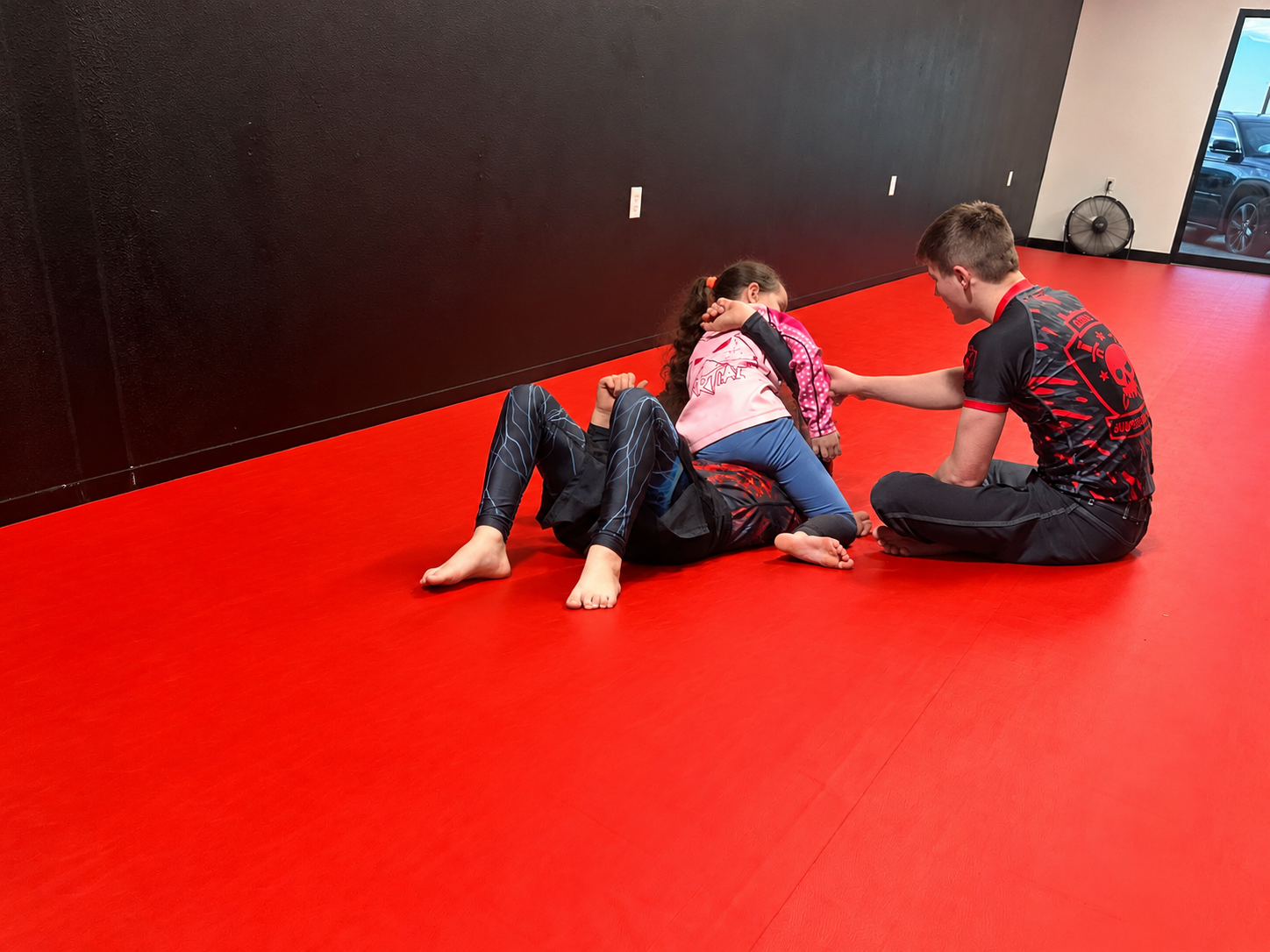 Kids Jiu Jitsu training on the red mats